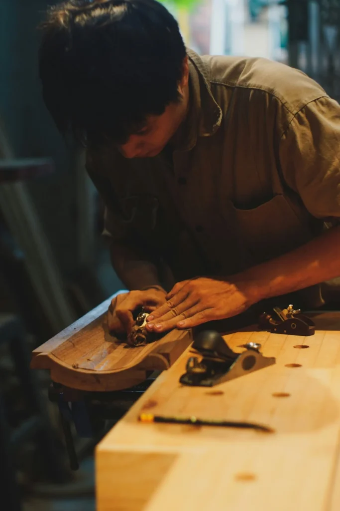 Craftsman refinishing a repaired door panel in a Los Angeles home