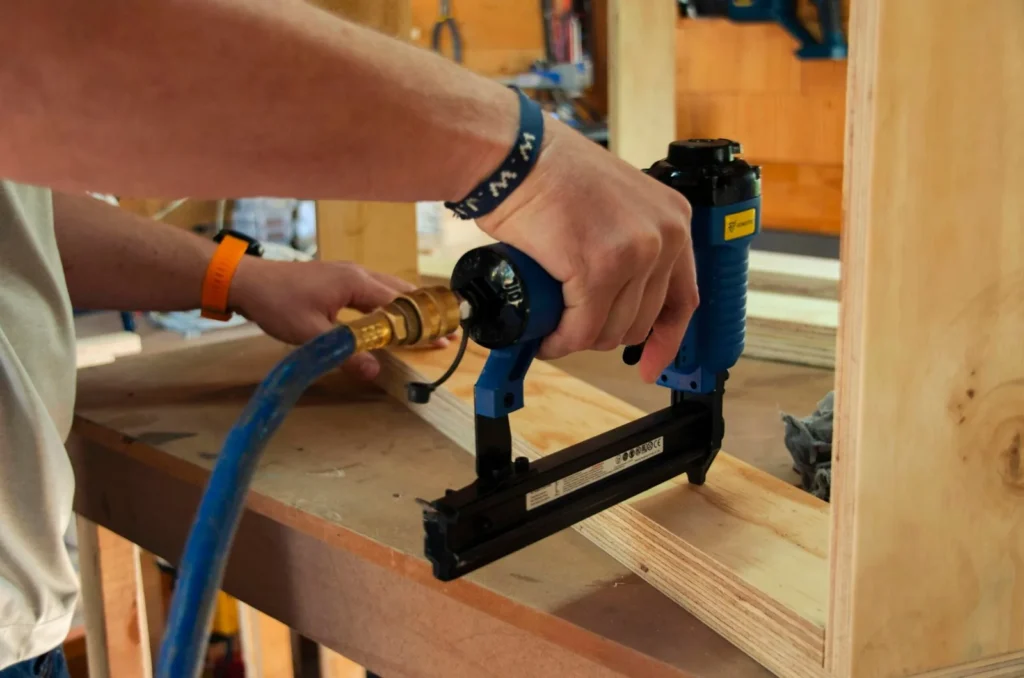 Handyman adjusting door hardware with a power drill in Los Angeles