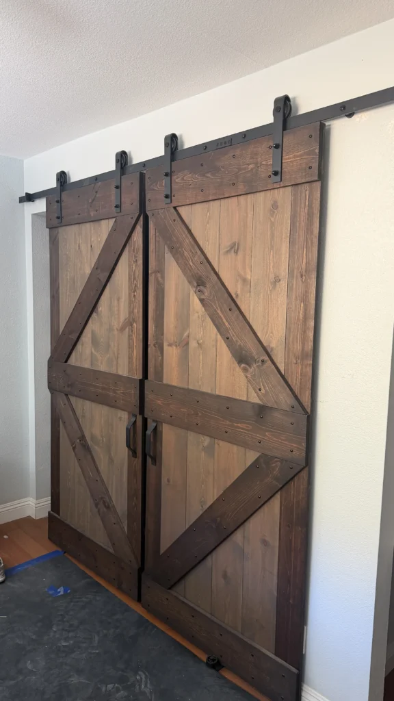 Wood sliding barn door installed in a Los Angeles hallway