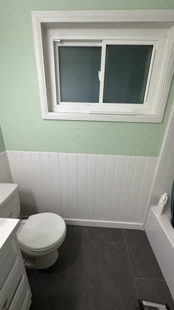 Bathroom refreshed with white wainscot and new paint in Los Angeles
