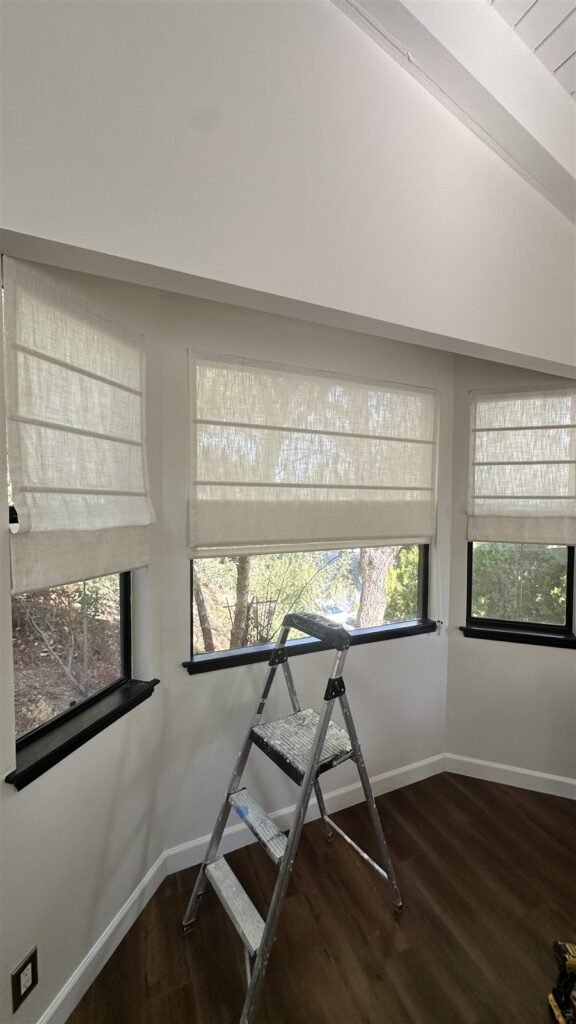 Woven roman shades installed across three windows in Los Angeles