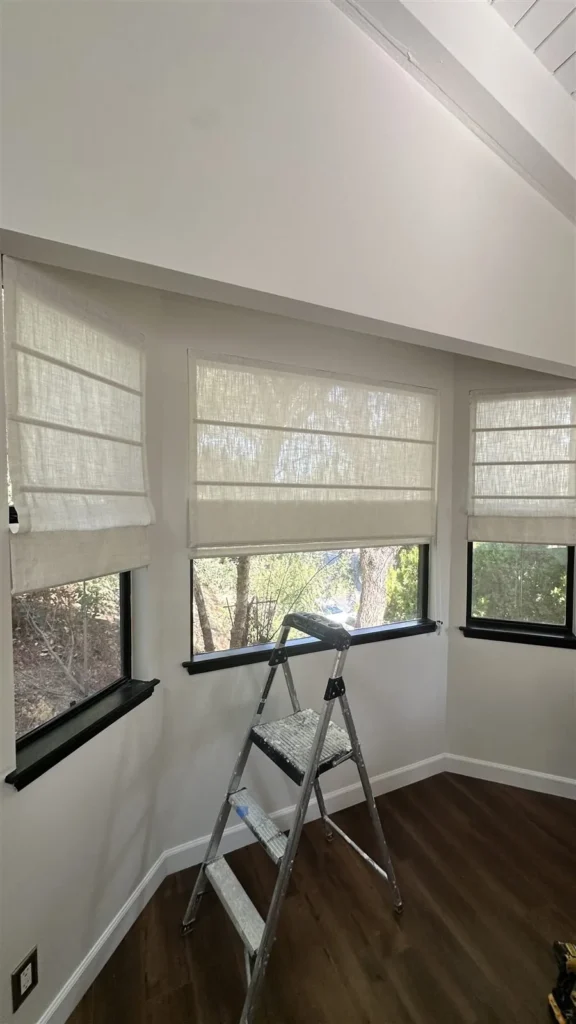 Woven roman shades installed across three windows in Los Angeles