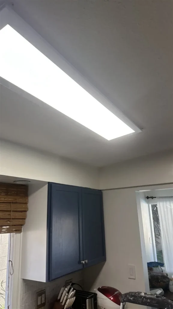 Navy blue cabinets and ceiling light in a Los Angeles kitchen
