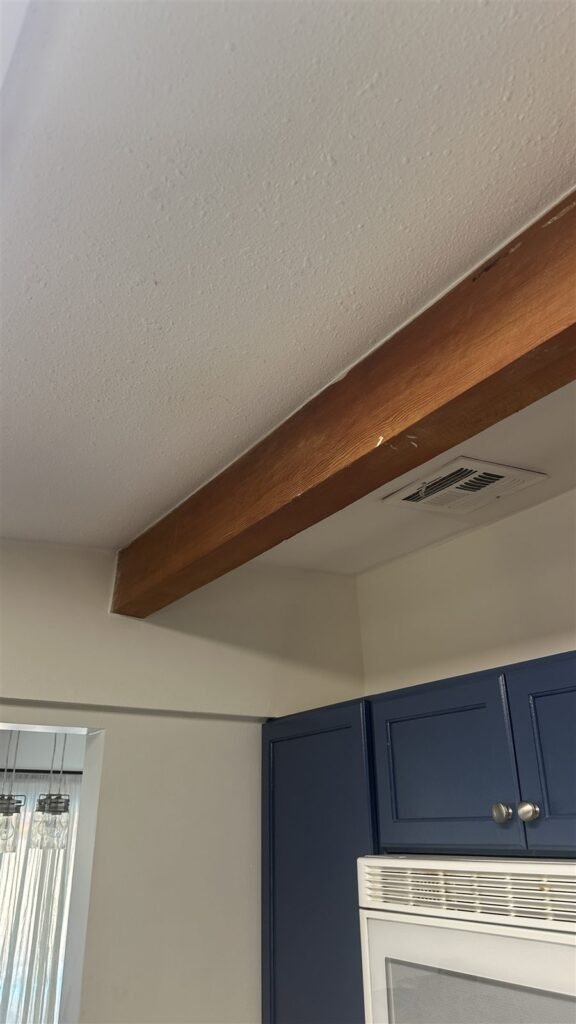 Navy blue cabinets and exposed beam in Los Angeles