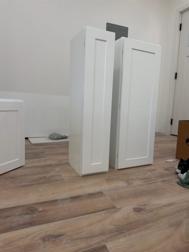 White shaker cabinets assembled on a new floor in Los Angeles