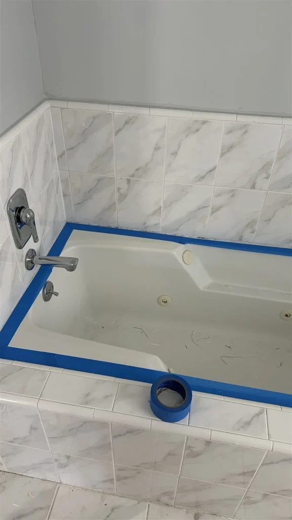 Tub surround masked for caulking in Los Angeles