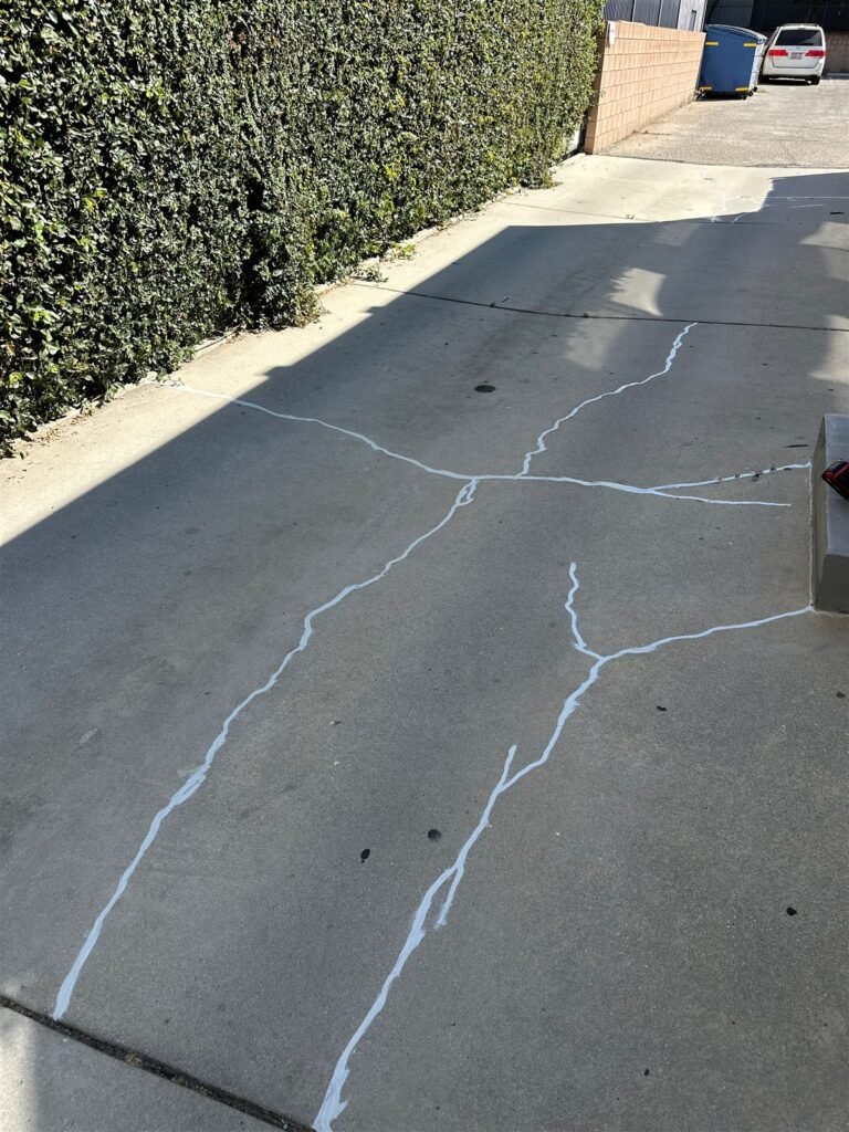 Cracked concrete driveway before repair in Los Angeles