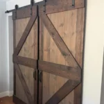 Double sliding barn door with black hardware installed in Los Angeles