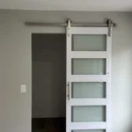 Sliding barn door with frosted glass panels installed in Los Angeles