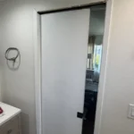 Flush sliding pocket door installed in a Los Angeles bathroom