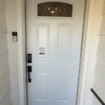 New white entry door with decorative glass and smart lock installed in Los Angeles