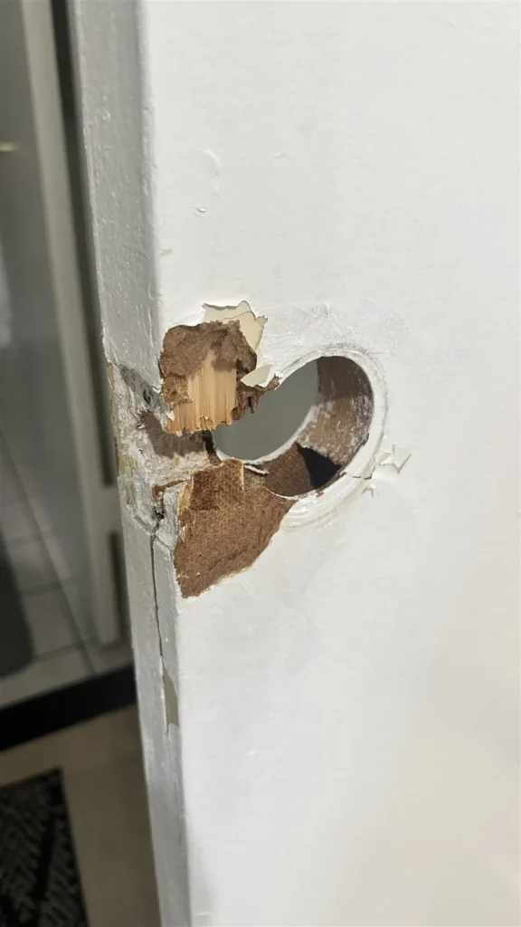 Door with damaged lock hole prepared for repair in Los Angeles