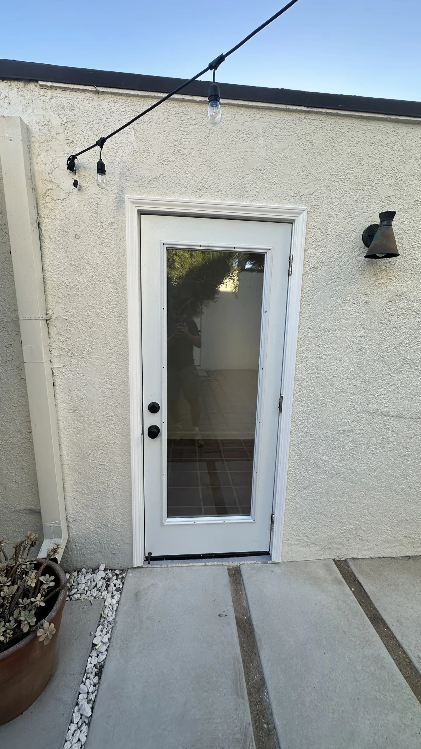 White exterior door with glass panes, closed and latched
