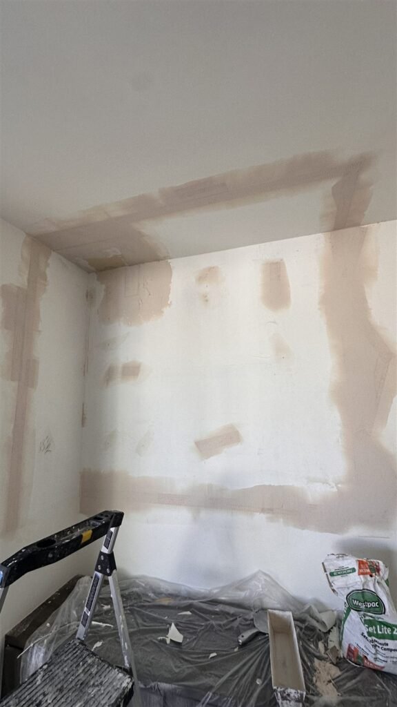 Wall repaired with joint compound before sanding in Los Angeles