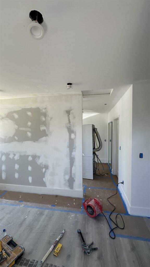Drywall repairs in a hallway before paint in Los Angeles