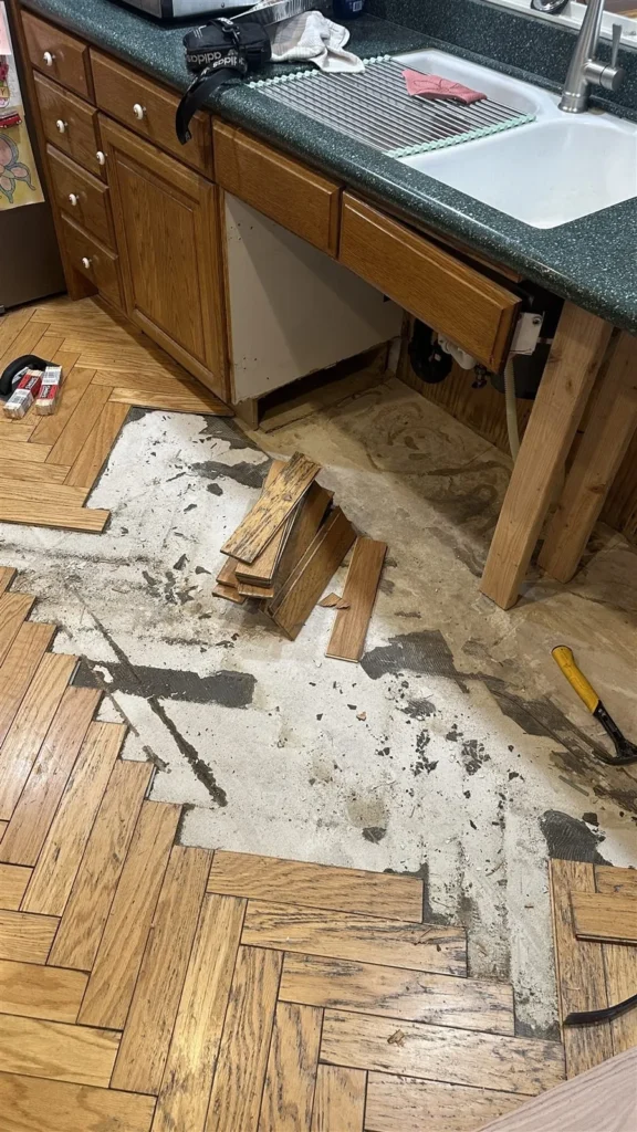 Parquet floor opened up for repair in a Los Angeles kitchen