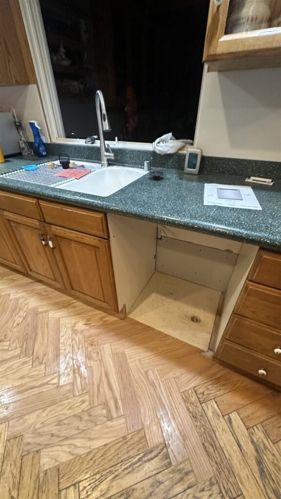 Refinished herringbone wood floor in a Los Angeles kitchen