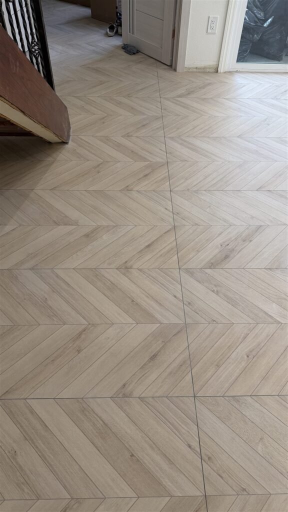 Herringbone porcelain tile floor installed in a Los Angeles home