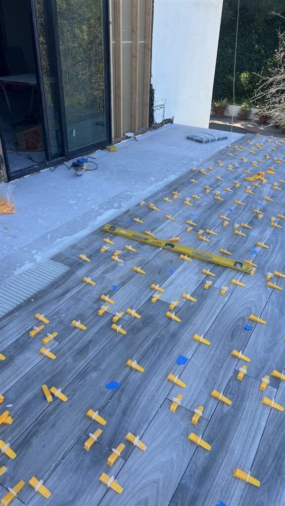 Large-format tile being laid on a Los Angeles patio