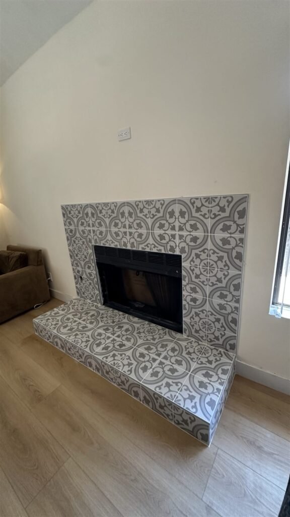Patterned tile fireplace and wood floor in Los Angeles