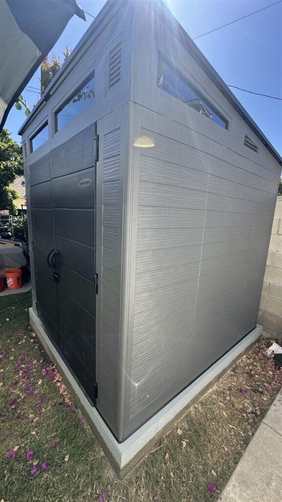 Gray storage shed assembled in a Los Angeles yard