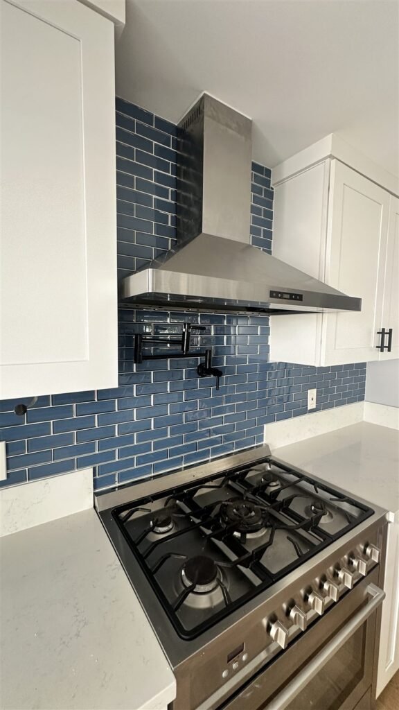 Blue subway tile backsplash and range hood installed in Los Angeles