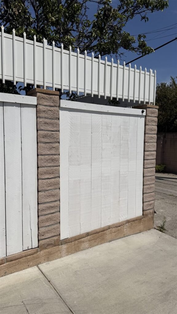 Freshly painted white fence panels in Los Angeles