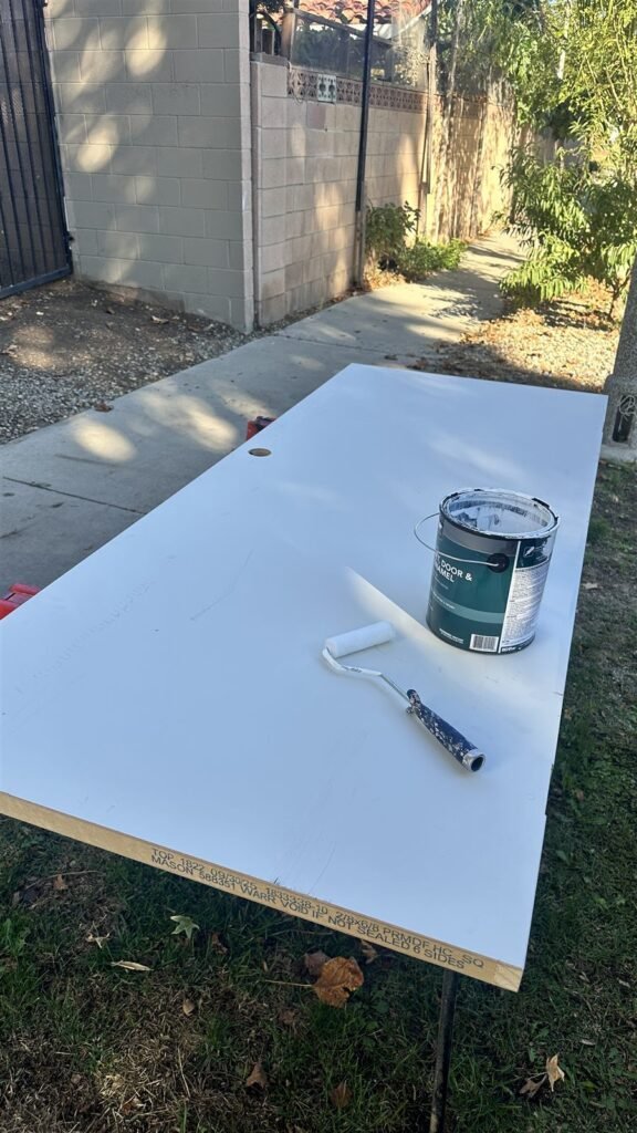 Door slab being painted white in a Los Angeles yard