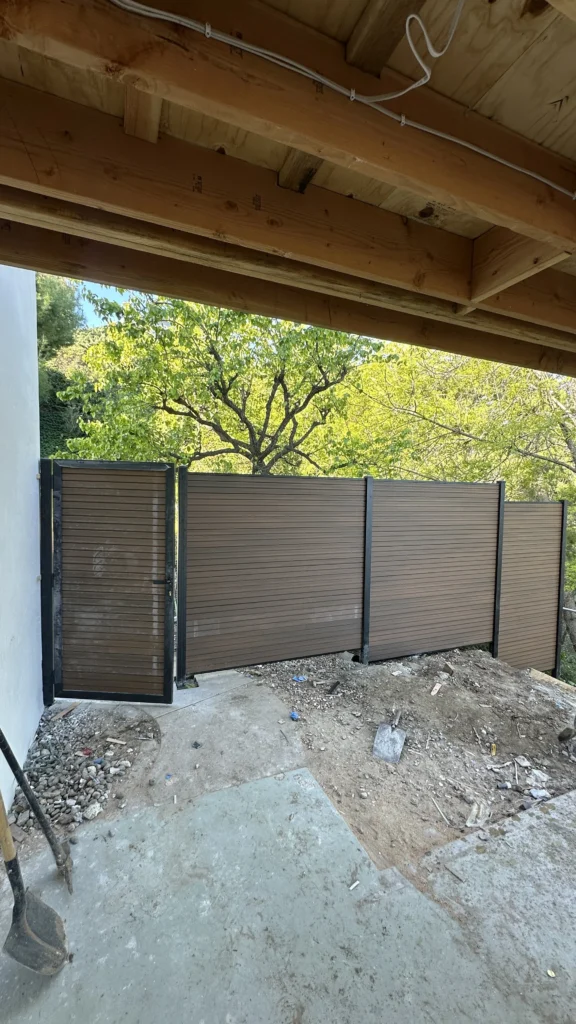 Wood fence gate repair in a backyard