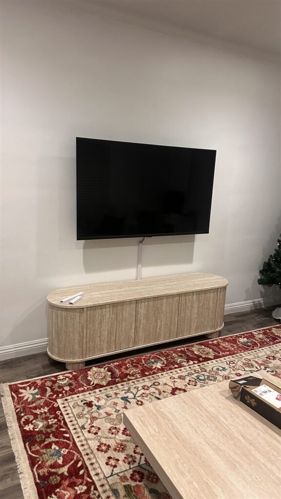 TV mounted on a wall above a console in Los Angeles