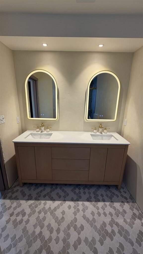 Double vanity with arched mirrors in a Los Angeles bathroom