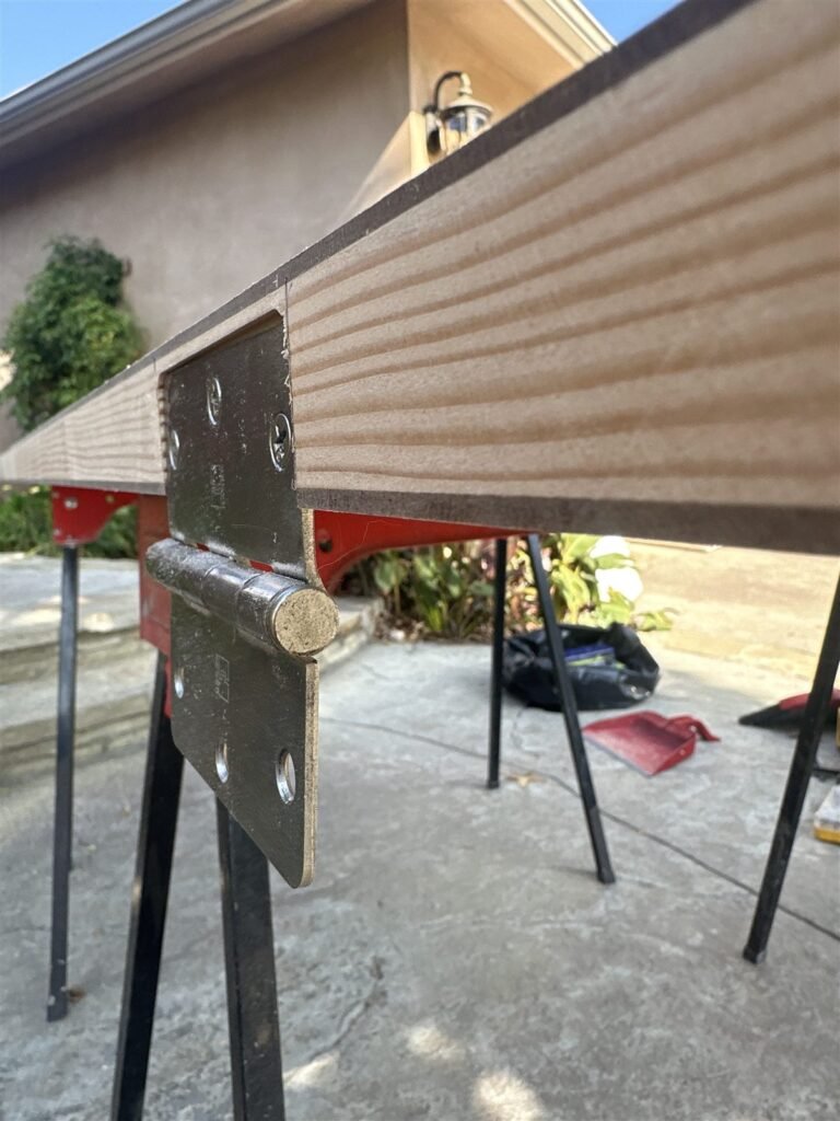 Metal hinge welded on a workbench in Los Angeles
