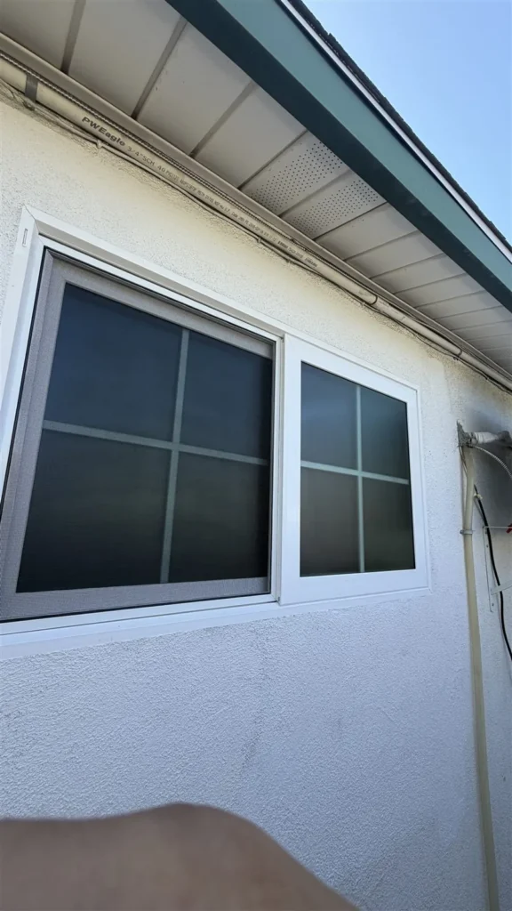 White-framed window with black grid installed in a Los Angeles home