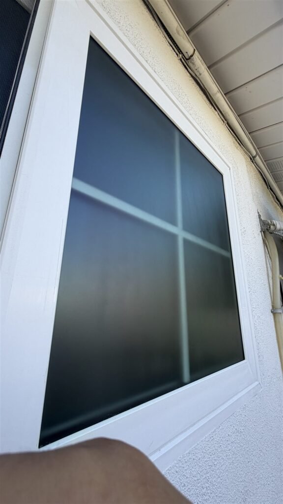 New window with dark glass and white frame installed in Los Angeles