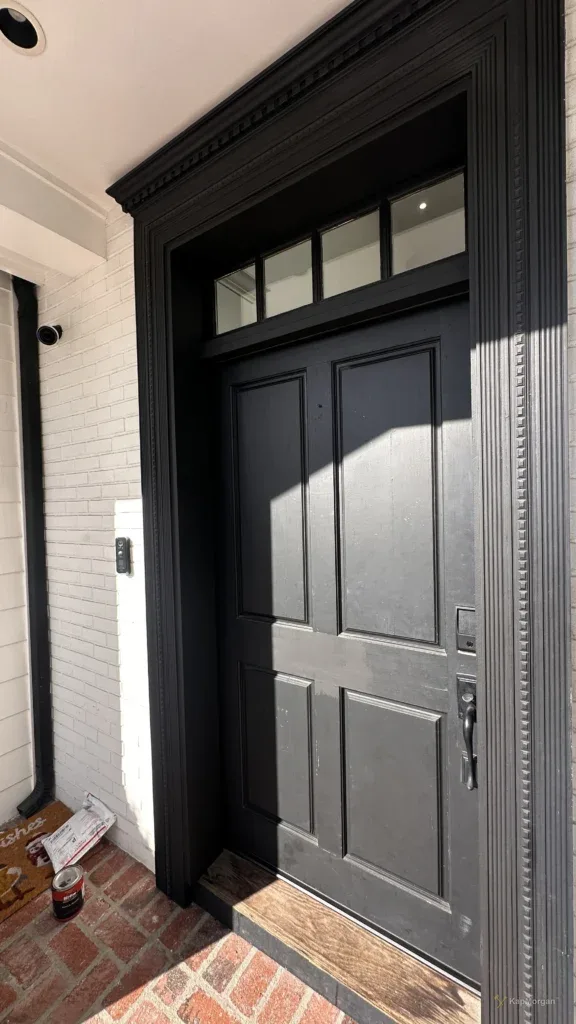 Black entry door with sidelights in a Los Angeles home