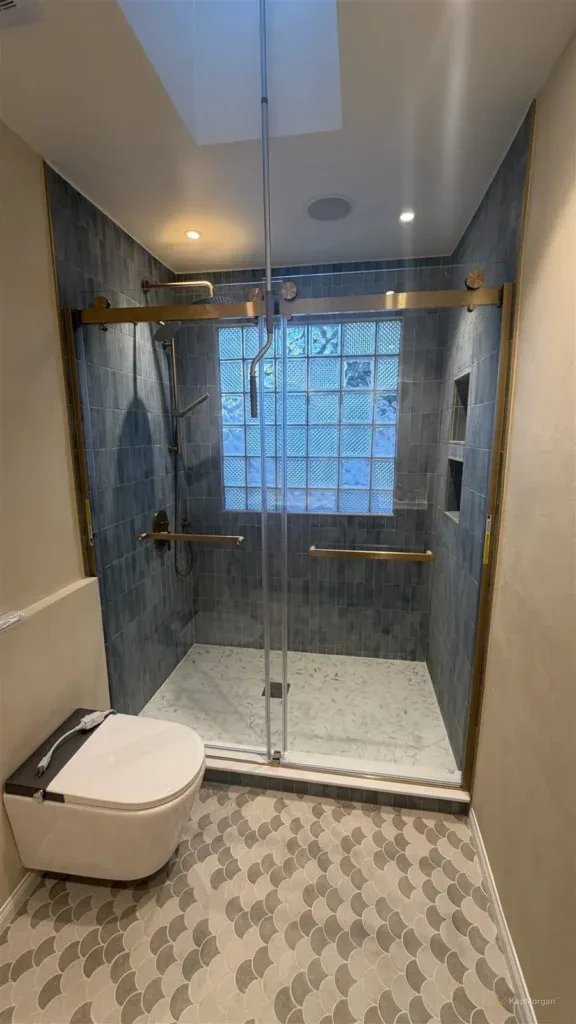 Blue tile shower with sliding glass door in Los Angeles